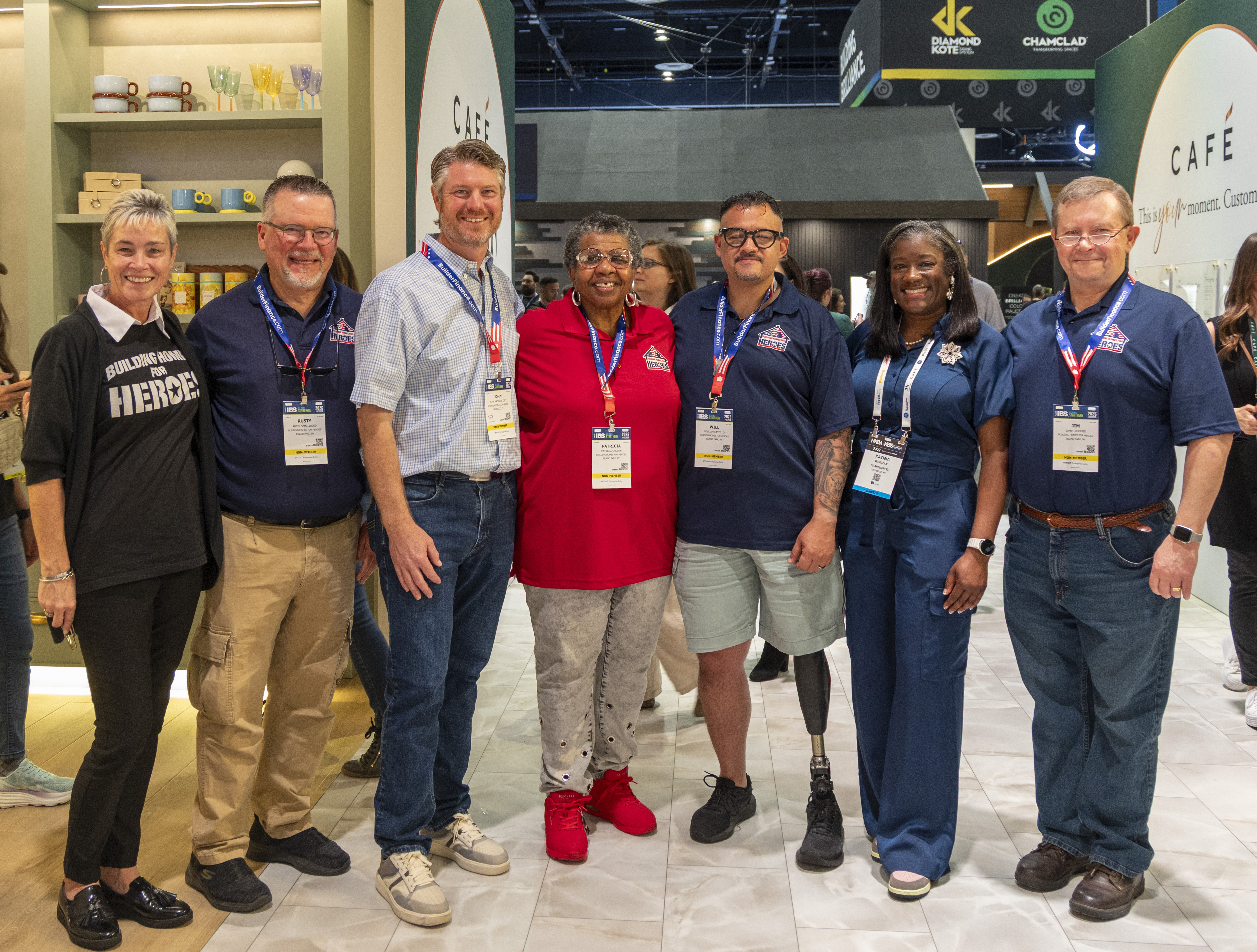 Group of individuals from Homes for Heros stand together smiling